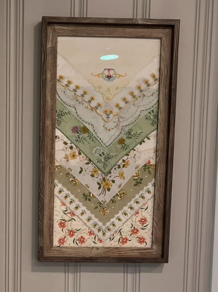 a framed quilt hanging on the wall