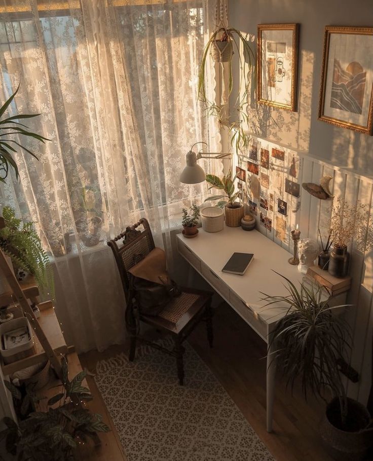 a home office with plants and pictures on the wall