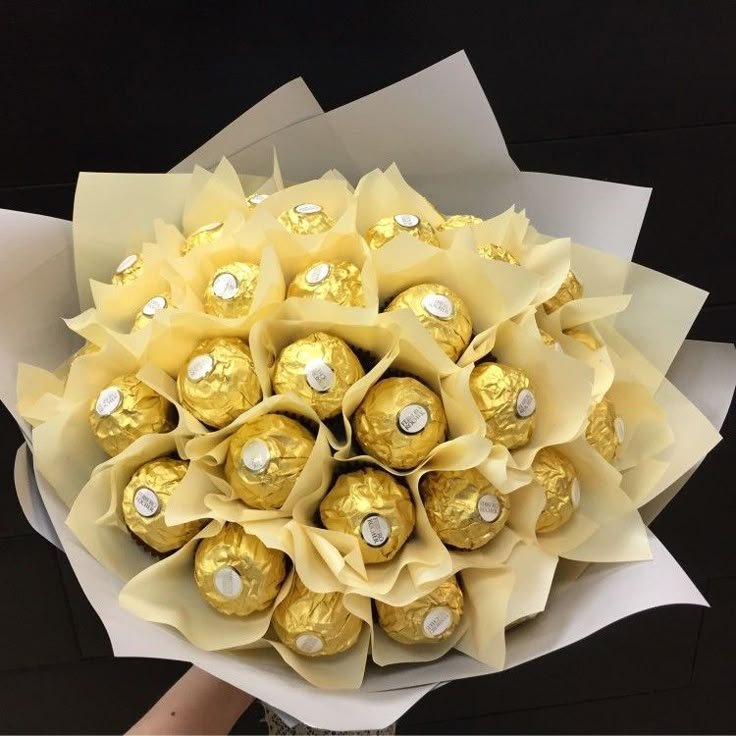 a bouquet of chocolates wrapped in white paper