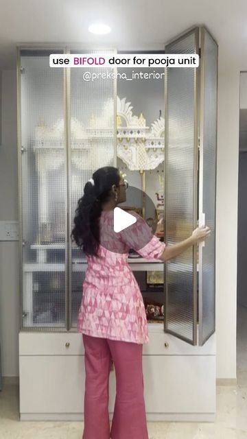 a woman standing in front of a display case