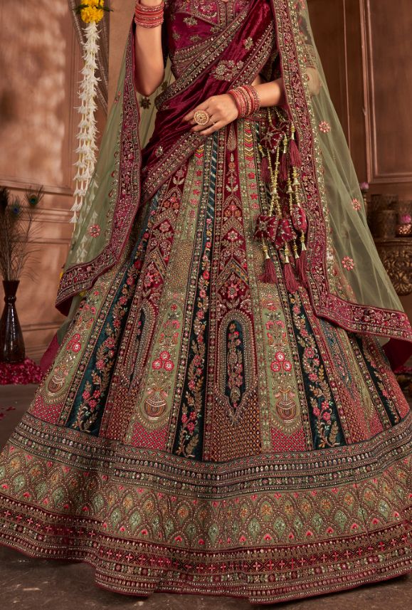 This stunning lehenga choli dress is crafted from luxurious fancy silk, creating a flawless look for any special occasion. Elevate your style with the vibrant color and elegant design, sure to turn heads and make you feel confident and beautiful! Perfect for adding a touch of glamour to any event. LEHENGA FABRIC: Velvet, SILK LEHENGA WITH HEAVY HANDWORK AND ZARKAN BLOUSE FABRIC: SILK DUPATTA: NET, VELVET WITH DOUBLE DUPATTA SIZING: Can be stitched upto 42 inches bust and waist SHIPPING: The product will be shipped within 1 - 2 weeks from the date of purchase. Stitched item will ship within 2-3 weeks from the date of the order All stitched products are final sale. We will contact you within 1-2 days from the date of order to confirm your measurements. Stitching Option - We will email you th Bridal Lehenga Maroon, Green Bridal Lehenga, Women Suits Party, Blue Bridal Lehenga, Double Dupatta, Maroon And Green, Suits Accessories, Choli Dress, Blue Bridal