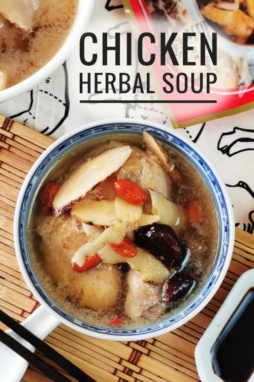 a bowl filled with soup sitting on top of a wooden table next to chopsticks