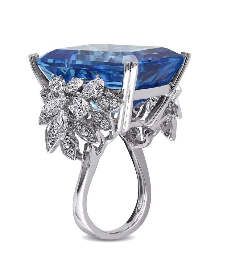 This exquisite one of a kind cocktail ring features an octagon-cut blue topaz center stone and multi-cut round, pear and marquise diamond side stones set in 14-karat white gold. This gorgeous ring is enhanced with a high polish finish. Asscher Cut Topaz Ring With Diamond For Formal Occasions, Luxury Diamond Rings From Macy's, Macy's Luxury Diamond Rings, Asscher Cut Topaz Ring Fine Jewelry For Formal Occasions, Asscher Cut Topaz Ring For Formal Occasions, Luxury Asscher Cut Topaz Ring For Formal Occasions, Formal Baguette Cut Diamond Topaz Ring, Formal Asscher Cut White Gold Topaz Ring, Macy's 14k White Gold Formal Rings