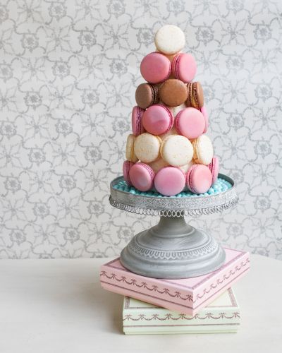 a three tiered cake made out of macaroons on top of each other