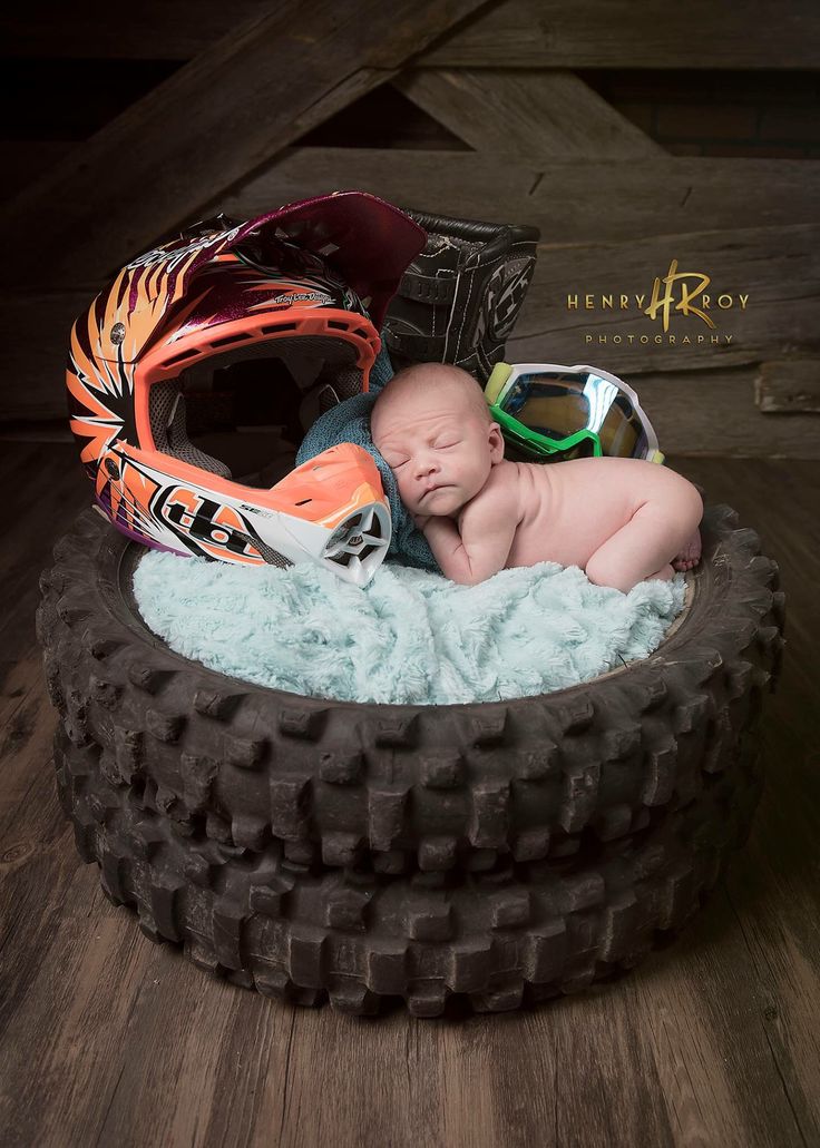 a baby in a tire with goggles and a helmet