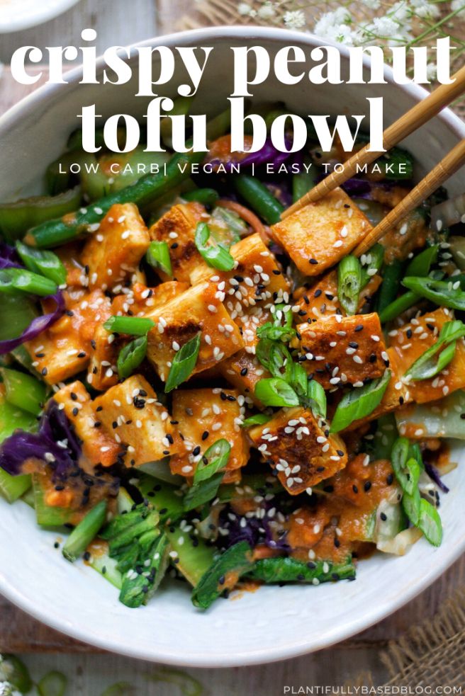 a white bowl filled with tofu and vegetables