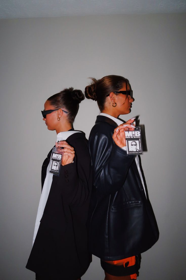 two women in black leather jackets and sunglasses