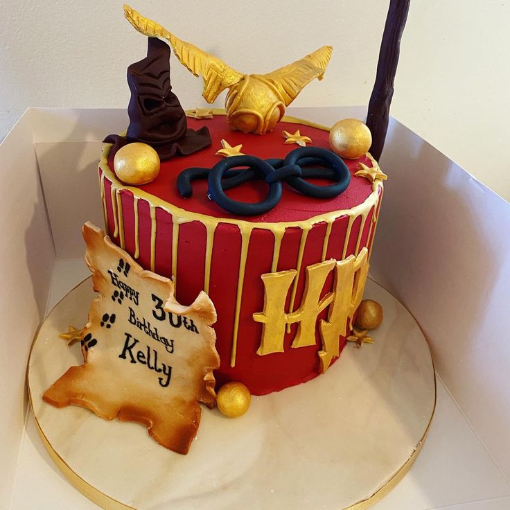 Red and gold gryffindor themed Harry Potter drip cake with gold drip, golden snitch sorting hat and other decorations and the inscription on a marauders map 30th Birthday Cake Harry Potter, Harry Potter Gryffindor Cake, Gryffindor Cake, Cake Pop Bouquet, Golden Magic, Character Cupcakes, Preston Lancashire, 21st Cake, Cupcake Gift