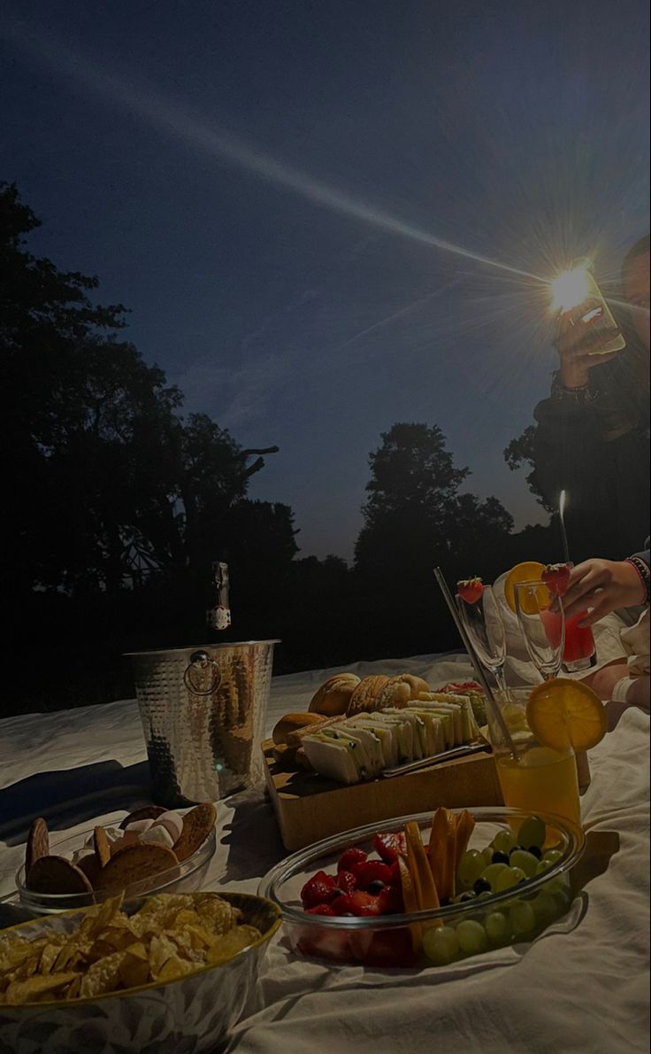 a woman sitting at a table filled with food