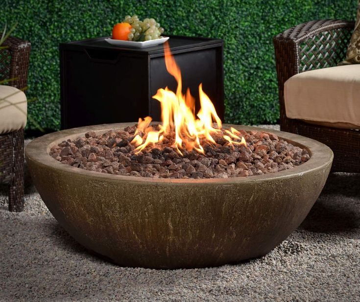 a fire pit sitting on top of a stone floor