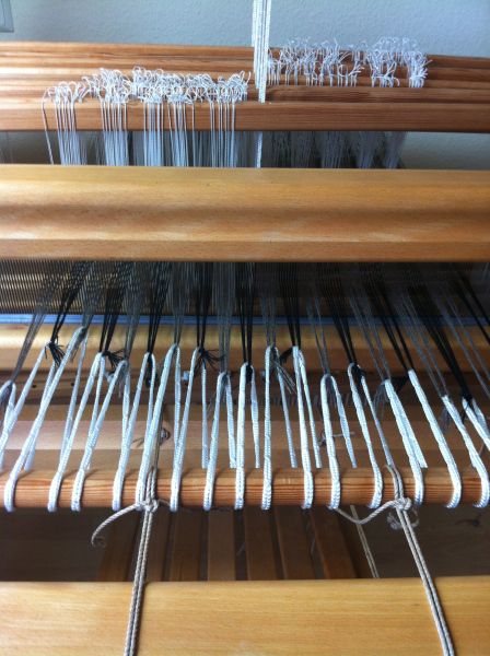 the loom is being worked on by someone