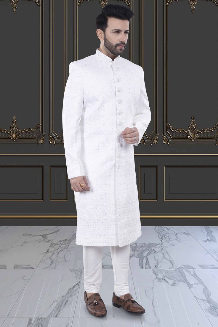 Expertly crafted, the Men's Sherwani in white presents a refined and sophisticated look. With delicate stone and thread embroidery, this Sherwani elevates your style for special occasions. Make a statement with this elegant and timeless piece. White Dabka Sherwani Traditional Fit, White Traditional Sherwani, White Transitional Sherwani With Traditional Fit, Transitional White Sherwani With Traditional Fit, Traditional Fit Sherwani For Wedding And Diwali, Wedding Sherwani For Diwali, Designer Formal Traditional Wear With Chikankari Embroidery, Embroidered Traditional Fit Sherwani For Wedding, Designer Traditional Wear With Chikankari Embroidery For Formal Occasions