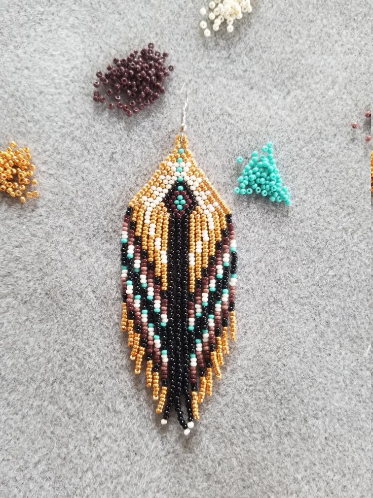 several beaded earrings laying on the ground