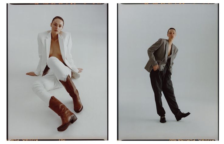 two men in white suits and brown boots are posing for the camera, one is leaning on his leg