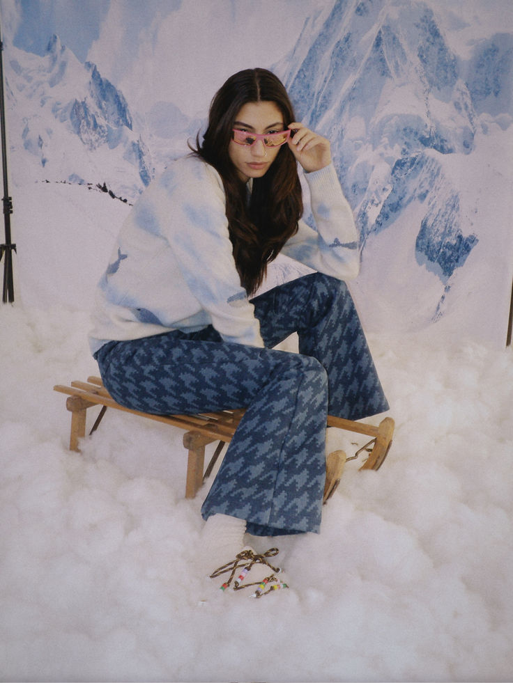 a woman is sitting on a sled in the snow