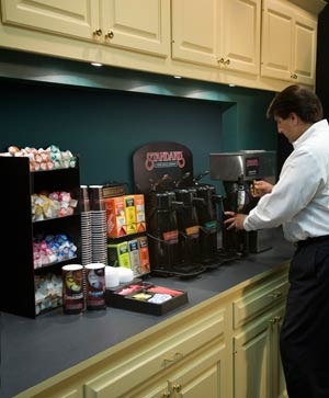 a man standing in front of a coffee machine