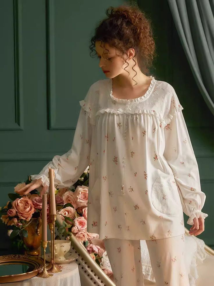 These Floral Print PJ Set has a French romance design style and a loose, comfortable, and elegant fit. The main material is cotton, which is made with Weaving technology to make the product more breathable and skin-friendly. Also, embroidered and elastic cuffs can make a person look more romantic and charming.  Type:  Pajamas  Color: White   Season: All Season  Style: Vintage/Romantic  Detail: Ruffled collar, Lace, Embroidered  Material: Cotton  Composition: 95% Cotton, 5% Polyester ＊Crafted fro Feminine Floral Cotton Sleepwear, Relaxed Fit Feminine Cotton Sleepwear, Spring Feminine Cotton Sleepwear, Feminine Cotton Sleepwear For Spring, White Cotton Cottagecore Sleepwear, White Cottagecore Cotton Sleepwear, Feminine Cotton Tops For Loungewear, Cotton Floral Print Sleep Top, Cotton Sleepwear With Floral Embroidery