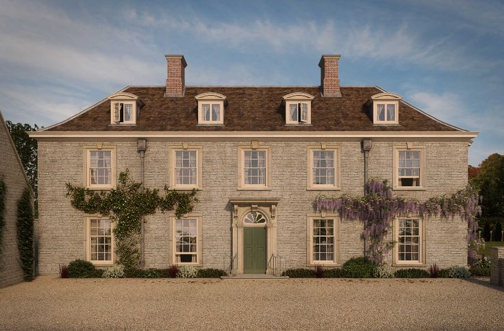 a large brick house with ivy growing on it's windows and doors, in front of a gravel driveway