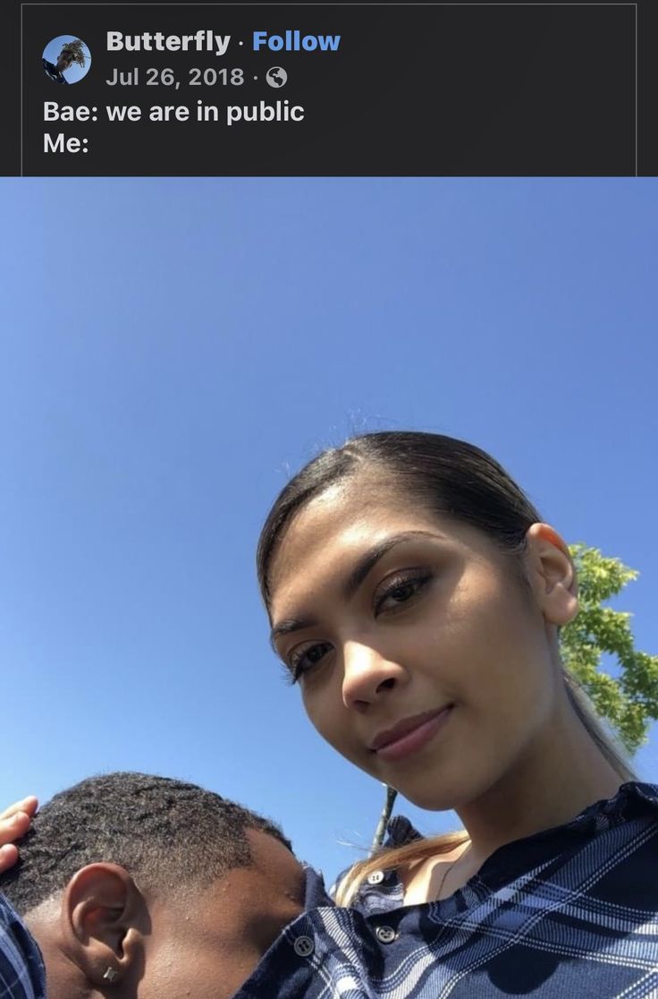 a man and woman standing next to each other in front of a blue sky with the words baes we are in public