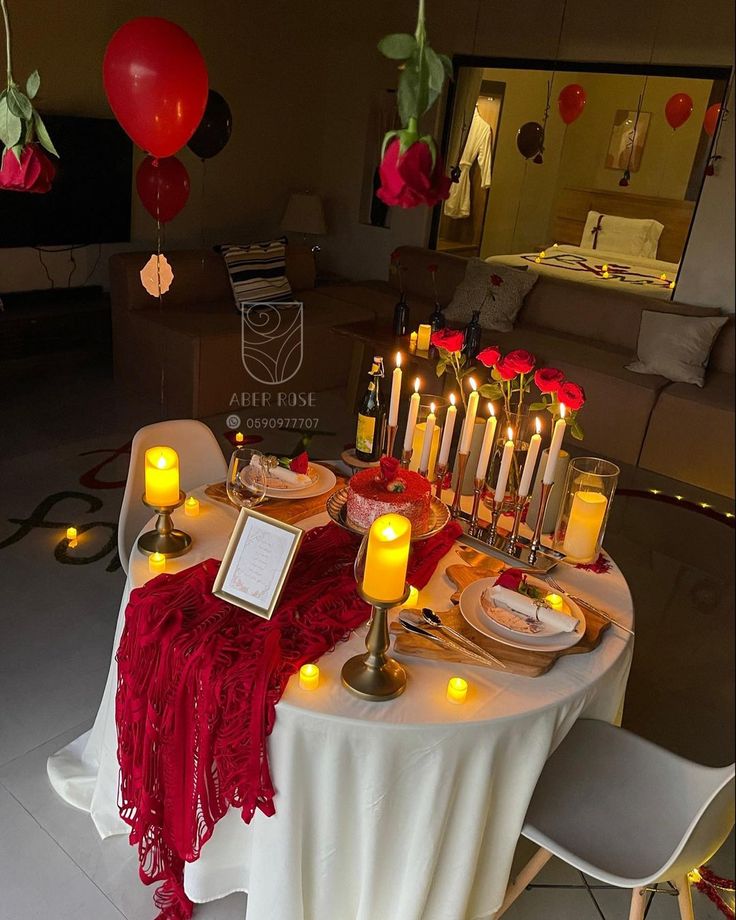 the table is set with candles, plates and napkins for an elegant valentine's day dinner