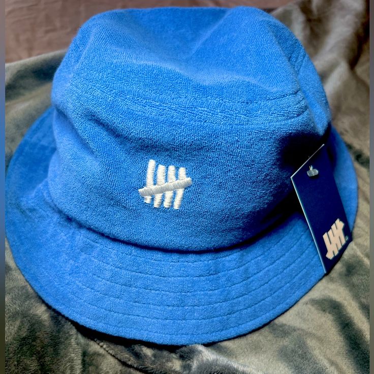 Size S/M Brand New W Tags Unisex Blue Bucket Hat With Flat Brim For Spring, Blue Cotton Bucket Hat With Flat Brim, Blue Winter Bucket Hat With Curved Brim, Blue Winter Bucket Hat, Blue Flat Brim Bucket Hat One Size, Blue Flat Brim Bucket Hat, Winter Blue Bucket Hat, Blue Short Brim Bucket Hat For Streetwear, Blue Bucket Hat For Streetwear