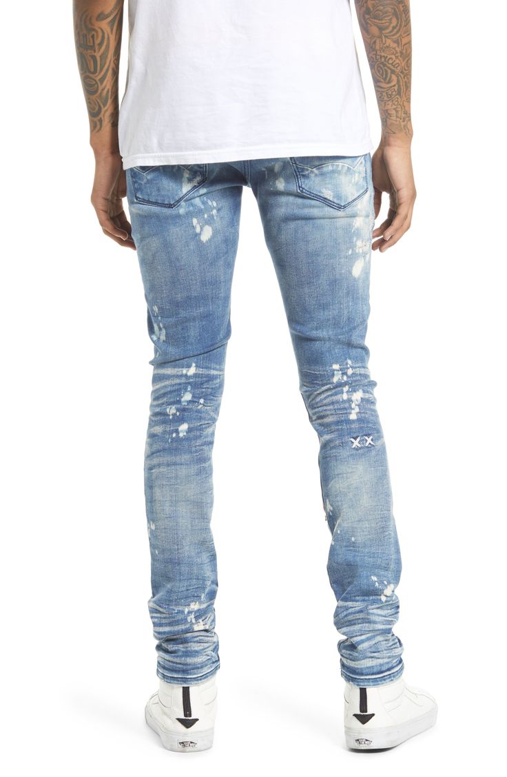 These super-skinny stretch-denim jeans are given a punk-rock update with a bleached wash covered in rips and paint splatters. A branded utility belt adds to the grunge aesthetic. 32" inseam; 11 1/2" leg opening; 10 1/2" front rise Zip fly with button closure Five-pocket style Removable utility belt 86% cotton, 10% spandex, 4% polyester Machine wash, line dry Imported Men's Clothing Distressed Slim Fit Cotton Jeans, Slim Fit Distressed Cotton Jeans, Distressed Slim Fit Jeans, Punk Style Distressed Blue Jeans, Fitted Punk Jeans In Dark Wash, Blue Distressed Punk Jeans, Punk Style Fitted Dark Wash Jeans, Fitted Dark Wash Punk Jeans, Edgy Slim Fit Jeans For Streetwear