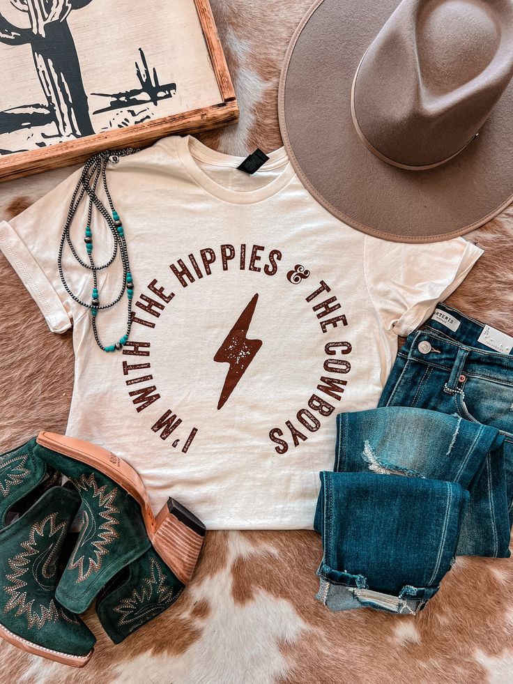 Just raisin hell with the hippies and the cowboys! This is the best tee and butter soft Fits true to size and is a inside fit 50% Polyester 25% Cotton 25% Rayon Model wears a medium and is a 4/6 and 5’8” Small - 2/4/6 Medium - 8/10 Large - 12/14 XL - 16 Western Hippie Fashion, Western T Shirts, Western Tees, Diy Graphic Tee, Soft Fits, Cute Country Outfits, Western Graphic Tees, Cute Shirt Designs, Western Aesthetic