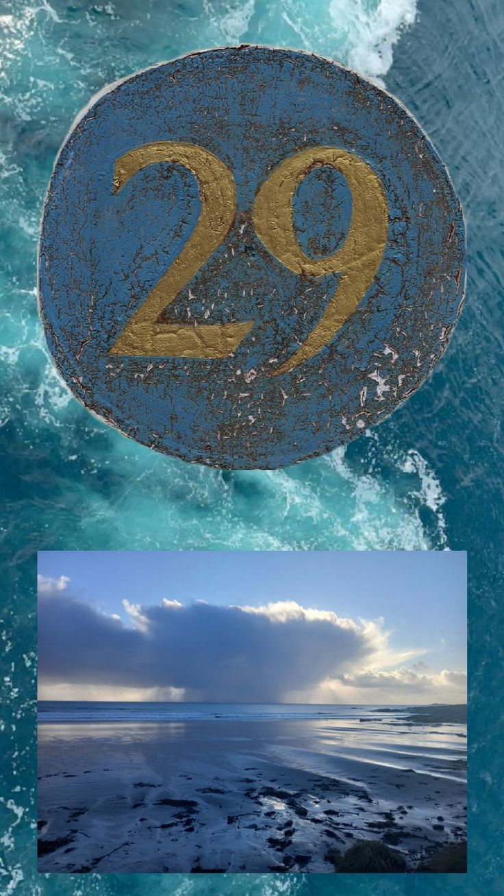 the number twenty nine is shown in gold and blue, along with an image of the ocean