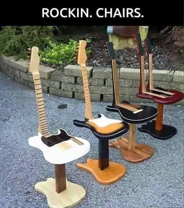 three guitars sitting on top of wooden stools