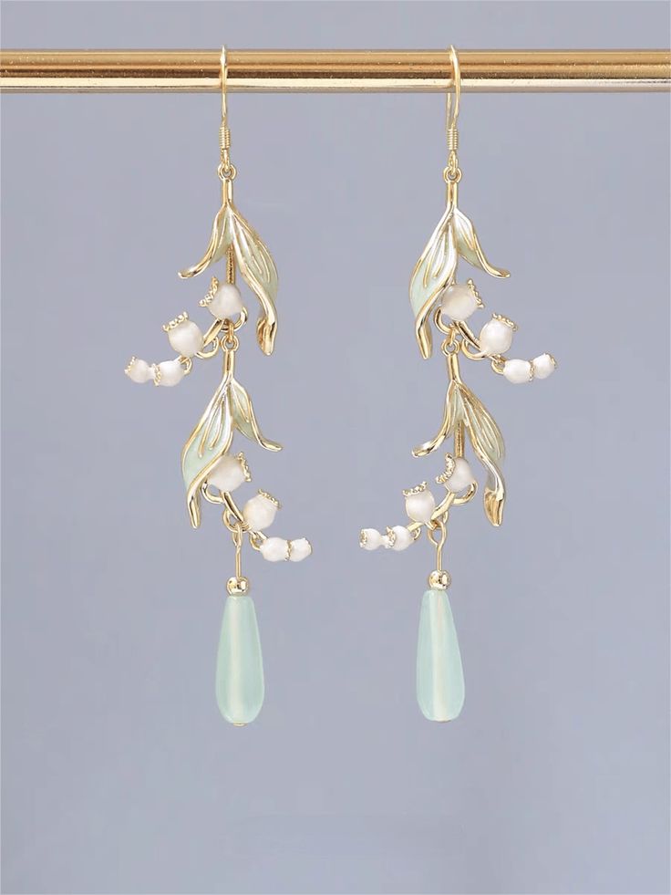 Elegant Lily Of The Valley Earrings Add a touch of elegance to your look with our Elegant Lily Of The Valley Earrings. Featuring delicate lilies, these earrings are perfect for any occasion. Transform your outfit into a charming and adorable look with these lovely earrings.