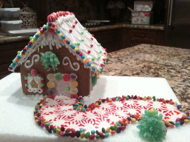 a decorated gingerbread house sitting on top of a counter