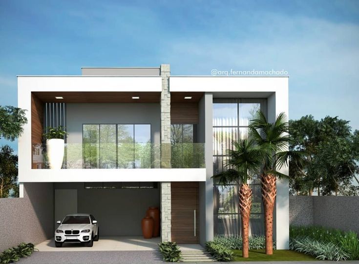 a car is parked in front of a modern house with palm trees and plants around it