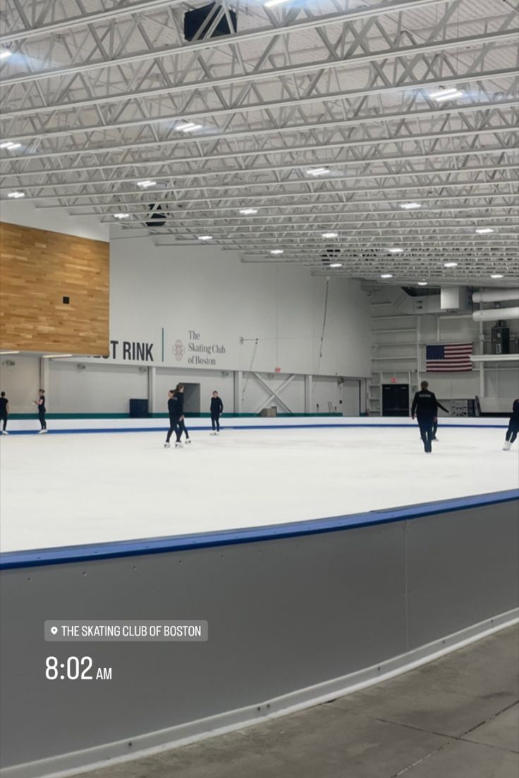 people skating on an ice rink in a building