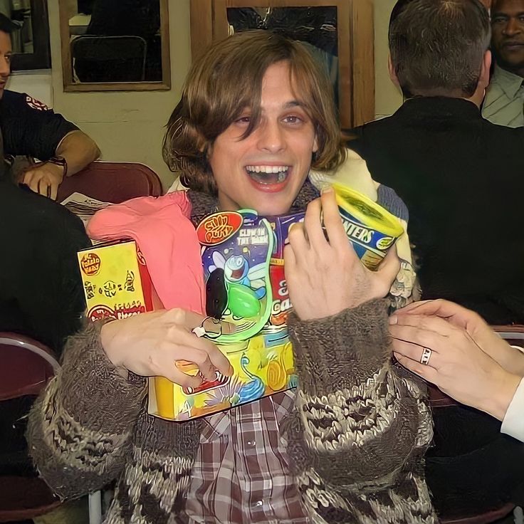 a woman is smiling and holding some food