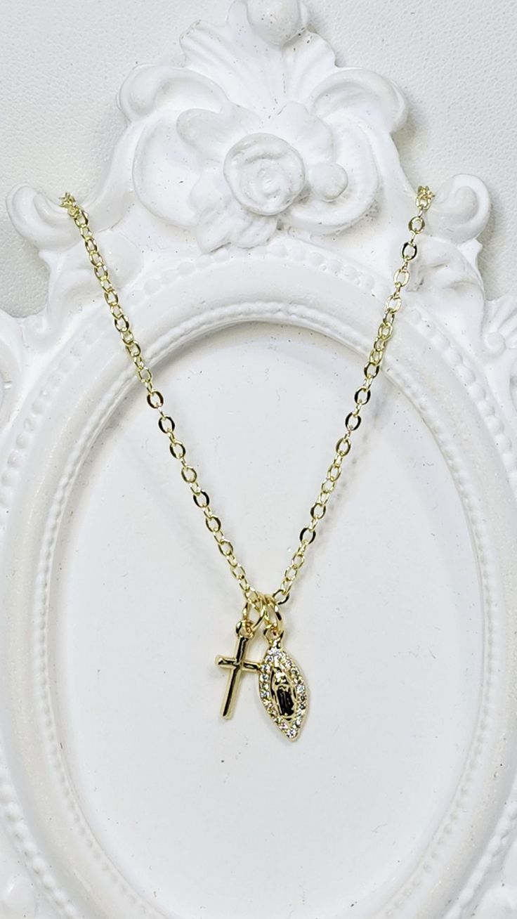 Gold Plated Brass Dainty 1mm Cable Chain is 16" with a 2" extender chain and lobster clasp. Necklace can be made shorter for children, by request in note section on order.  Gold Filled Brass Cross is 12x6mm Gold Filled Brass and Cubic Zirconia Mary Charm is 14.5x5.5mm Minimalist Gold Crucifix Charm Necklace, Dainty Charm Necklace With Cross Pendant, Tarnish Resistant, Dainty Yellow Gold Crucifix Necklace, Spiritual 14k Gold-filled Charm Necklace, 14k Gold-filled Spiritual Charm Necklace With Adjustable Chain, Catholic Jewelry, Gold Cross Necklace, Blessed Mother Mary, How To Make Shorts