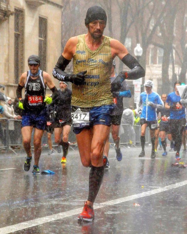 a group of people running in the rain