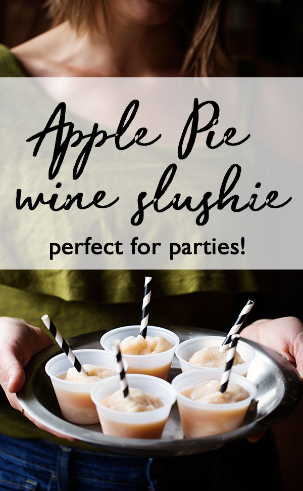 an apple pie wine slushie is served on a silver platter with black and white striped straws