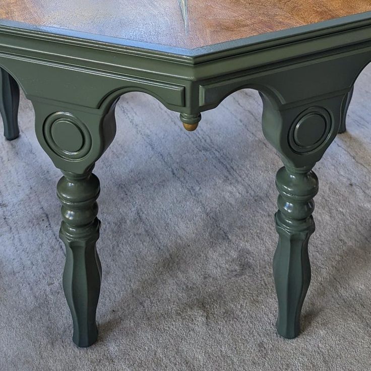 a green table sitting on top of a carpeted floor