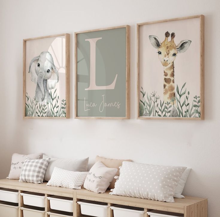 three framed pictures hang on the wall above a bench filled with pillows and storage bins