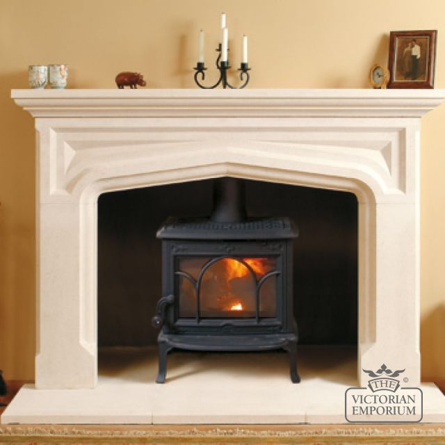 a fireplace with a fire burning in it's mantle and two candles on the mantel