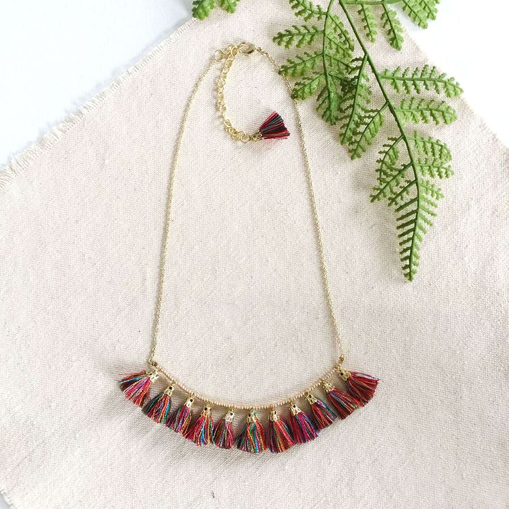 Brilliant, rainbow-colored tassels dangle from a gold-toned chain for an incredibly vivid yet delicate piece. Measures 17″ long + a 3″ extender. Sustainably handmade by women artisans in India. Rainbow Fringe Dangle Jewelry, Gold Tassel Necklaces For Festival, Multicolor Necklaces With Latkans For Gifts, Gift Multicolor Necklaces With Latkans, Multicolor Fringe Jewelry As A Gift, Gold Tassel Necklace With Fringe For Gift, Multicolor Fringe Necklace For Festival, Gold Tassel Necklace For Festivals, Multicolor Long Tassel Necklace