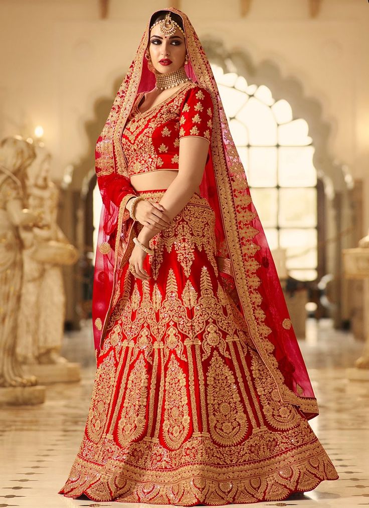 a woman in a red and gold bridal gown