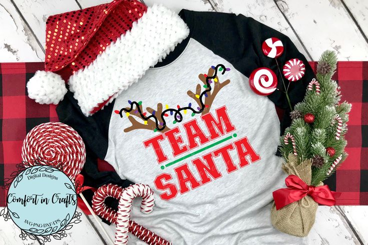 a shirt that says team santa on it with candy canes and christmas decorations around it