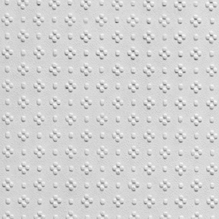 white textured wallpaper with small circles and dots on the bottom half of it