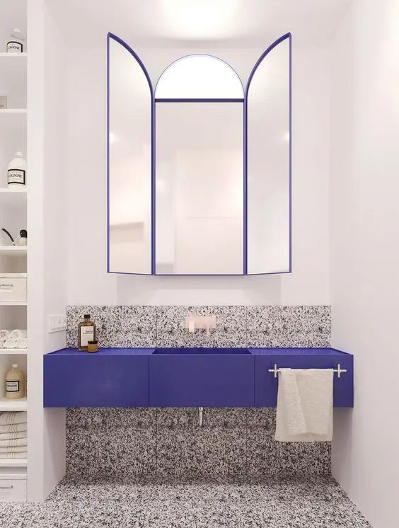 a bathroom with a blue sink and mirror