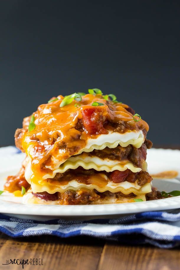 a stack of lasagna stacked on top of each other with cheese and sauce