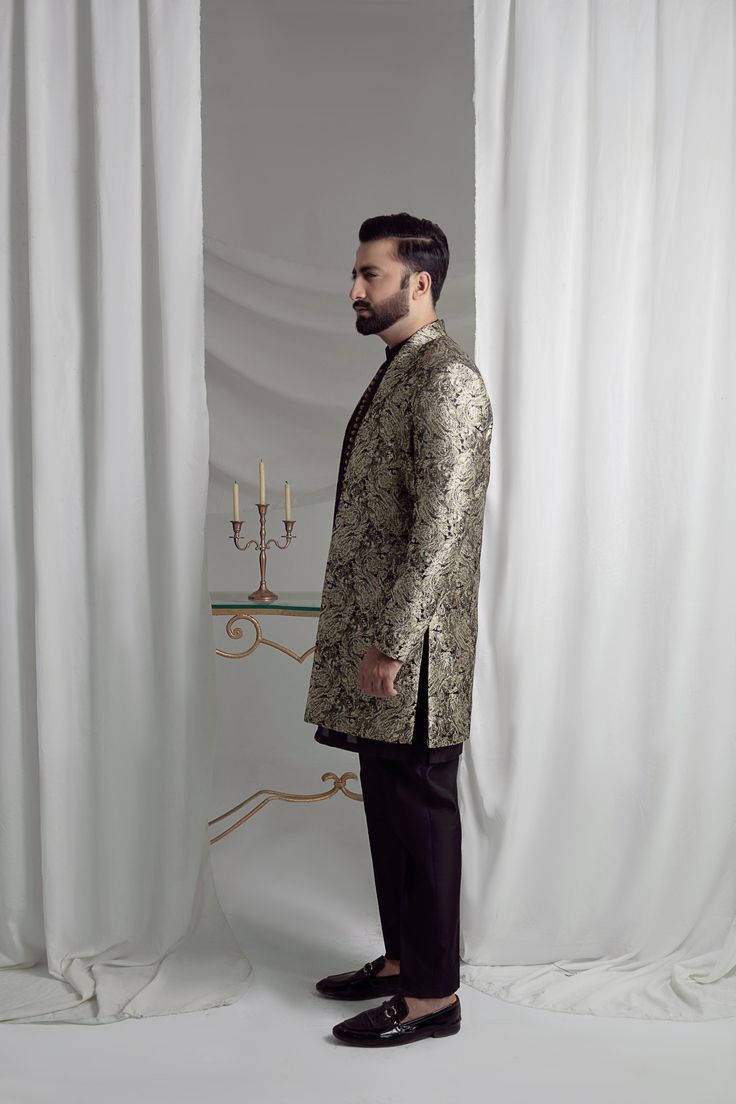 Upgrade your style with our Black and Gold Prince Coat. Made from luxurious brocade material, this front open coat exudes royalty. Paired with an Indian raw silk kurta pajama, it's the perfect ensemble for any formal event. Elevate your look and make a statement with this unique and elegant piece. 3-Piece Suit Traditional Resham Embroidery Bandhgala For Formal, Traditional Bandhgala With Resham Embroidery, Elegant Bandhgala With Resham Embroidery For Diwali, Designer Long Sleeve Bandhgala For Formal Events, Designer Long Sleeve Bandhgala For Formal Occasions, Elegant Semi-formal Sets For Eid, Designer Party Kurta With Traditional Drape, Designer Unstitched Suit For Eid Party, Designer Unstitched Bandhgala For Festive Occasions