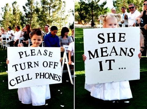 two children holding up signs that say she means it