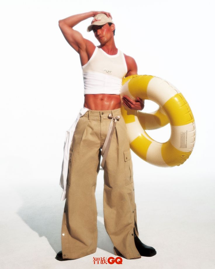 a man is holding an inflatable life preserver and posing for the camera