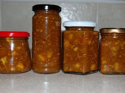 three jars filled with food sitting on top of a counter